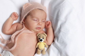 Canvas Print - Cute little baby with toy bear sleeping on soft bed, top view