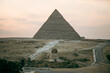 The great sphinx and pyramids under bright sun. view of the Giza plateau with the great pyramids and the sphinx in the evening at sunset