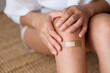 © Farknot Architect - Closeup image of a young woman with adhesive bandage, medical plaster, band aid on her knee