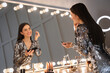 © New Africa - Young woman applying make up near illuminated mirror indoors