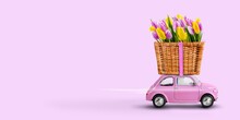 Pink Toy Car Delivering Flowers Tulips In A Basket On A Pink Background.
