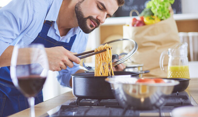 Man preparing delicious and healthy food in the home kitchen