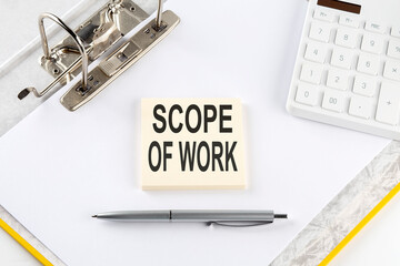 Poster - SCOPE OF WORK - business concept, message on the sticker on folder background with calculator