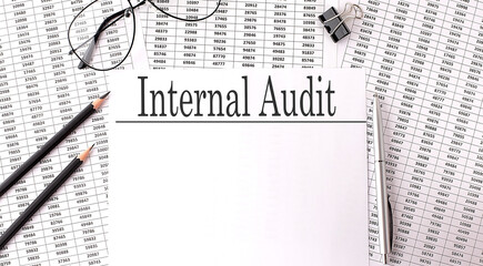 Poster - Papers with text INTERNAL AUDIT on table, business concept.
