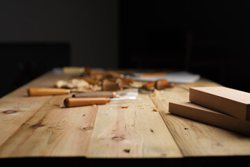 Canvas Print - Wood carving process concept with free space on top. Focus on an empty space in the foreground. Mockup background for product presentation