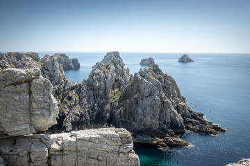 Wall Mural - Scenic view of rocky cliff on sea