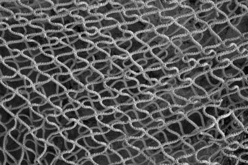 evocative black and white image of fishermen net texture 
