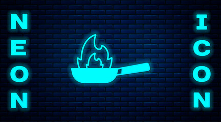 Sticker - Glowing neon Pan with fire icon isolated on brick wall background. Vector