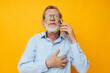 © Tatiana - old man gray beard with glasses talking on the phone isolated background