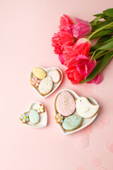 Wall Mural - Easter floral background, various gingerbread glazed cookies end decorated with natural botanical elements on pink, flat lay, view from above, blank space for greeting text, banner, flyer, coupon