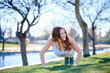 © Carlos - beautiful young woman exercising in a park