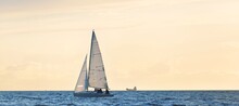 Small Yacht Sailing In The Baltic Sea At Sunset. Transportation, Travel, Cruise, Sport, Recreation, Leisure Activity, Racing, Regatta