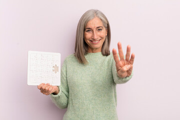 Wall Mural - middle age woman smiling and looking friendly, showing number four. puzzle challenge concept