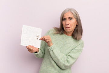 Wall Mural - middle age woman with a puzzle. challenge concept