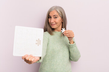 Wall Mural - middle age woman with a puzzle. challenge concept