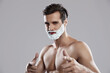 © Drobot Dean - Confident caucasian man with shaving foam on face