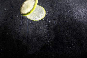 Wall Mural - Water drops on ripe sweet lemon. Fresh lime  background with copy space for your text. Vegan concept.