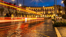 Cars Light Trails In The Evening Square In Rome Right After The Rain. Night Traffic Routes. Motion Blur. Cityscape.
