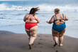 © DisobeyArt - Plus size friends walking on the beach having fun during summer vacation - Focus on girls back
