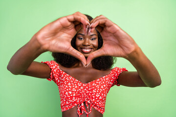 Sticker - Photo of cool millennial curly hairdo brunette lady hands heart wear red top isolated on green color background