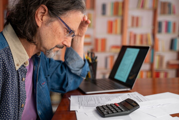 Frustrated mature man feels angry unable to do tax preparation successfully get debt deficit try to find mistake in calculations. Annoyed male business costs think on bankruptcy risks too high taxes