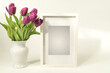 White wooden picture frame mockup with magenta pink tulips bouquet. Empty frame mock up or template for presentation design.