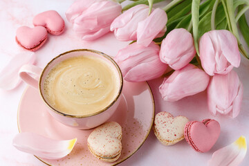 Vintage pink coffee cup, tulip flowers and french sweet cookies macarons macaroons  on marble background