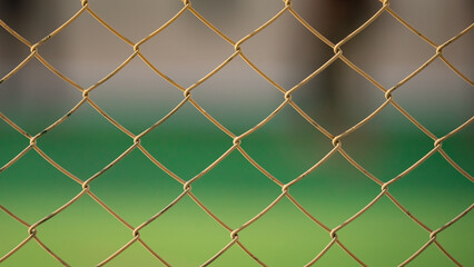 Close up of old chain fence at a football ground.