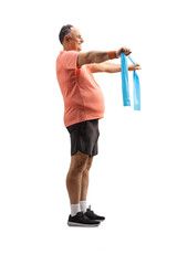 Poster - Full length profile shot of a mature man in sportswear exercising with a stretch strap