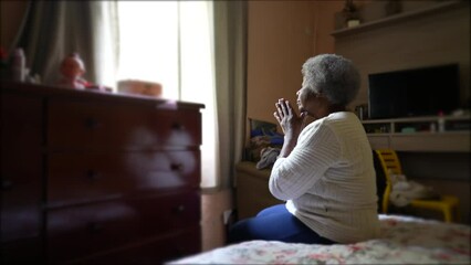 Wall Mural - A spiritual older person praying in bedroom candid casual home