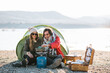 © ADDICTIVE STOCK - Happy couple of travelers near tent at campsite