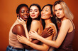 © iordani - young pretty caucasian, african, scandinavian woman posing cheerful together on brown background, lifestyle diverse nationality people concept