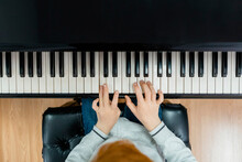 Crop Child Playing Piano At Music Class