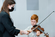 Boy And Teacher At Violin Lesson