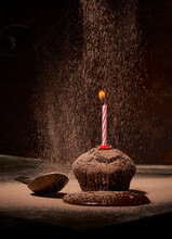 Tasty Muffin With Smoking Birthday Candle