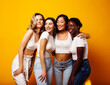 © iordani - diverse multi nation girls group, teenage friends company cheerful having fun, happy smiling, cute posing on yellow background, lifestyle people concept, african-american, asian and caucasian