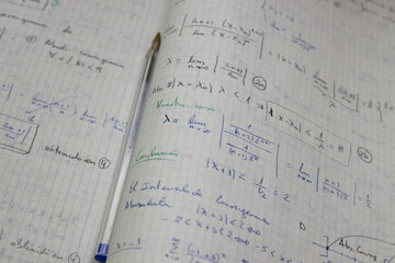Close-up of a notebook with mathematical limits exercises