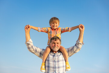 Wall Mural - Grandfather and boy having fun outdoor