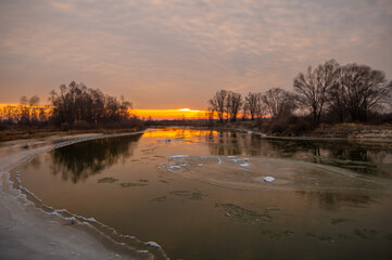 The river is covered with ice, ice floes are floating, winter,element, dawn, sunset, freezing, the power of nature, global warming, flood, floodspring, March, April