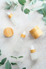 Wall Mural - natural cosmetics set on stone table with eucalyptus leaves. flat lay, top view.