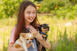 © Lesia - Cute girl 10 or 11 years old with her dogs in her arms in black and white. Teenage girl with pets.