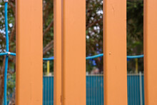 Looking Trhough Bright Yellow Bars Of Playground