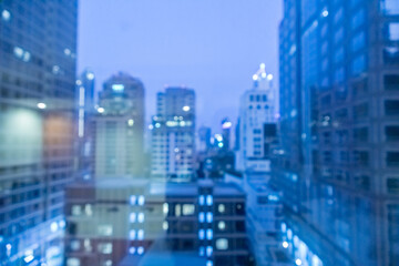 Poster - Blur image of city scape building in the night with light bokeh