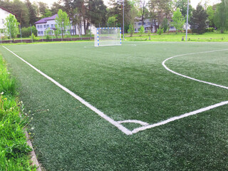 football field with markings.Texture of natural green grass on the football field. green grass stadium background. Top view of soccer field. 