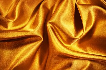 Wall Mural - Golden silk satin. Wavy folds. Shiny surface fabric. Beautiful silky background with space for design.