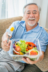 Mature man with pumpkin and healthy food, Portrait Asian Senior man eating a salad in house, Old elderly male health care eat vegetables and useful foods.