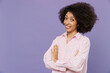 © ViDi Studio - Young smiling cheerful happy confident friendly woman of African American ethnicity wear pink and white striped shirt hold hands crossed folded isolated on plain pastel light purple background studio.