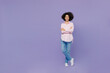 © ViDi Studio - Full body smiling happy young woman of African American ethnicity 20s wear pink striped shirt hold hands crossed folded look camera isolated on plain pastel light purple background studio portrait