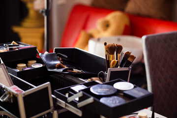 Dedicated focus Make-up converter on makeup artist's table with lots of makeup artist tools. The stack surrounds the makeup artist's table, leaving room for text.