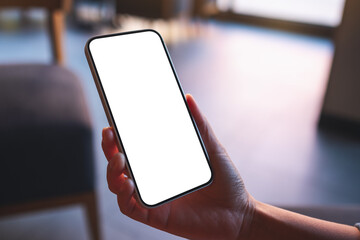 mockup image of a woman holding and using mobile phone with blank desktop screen